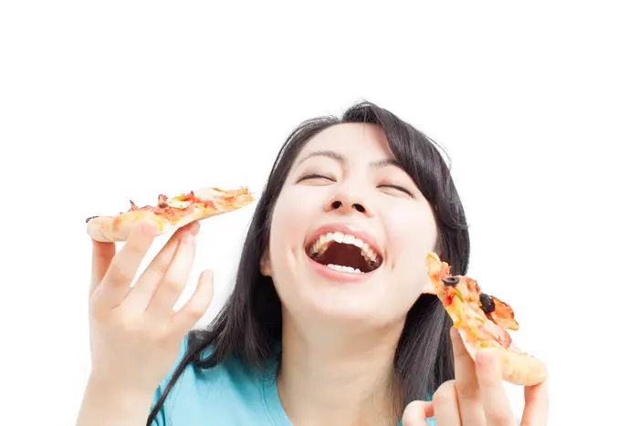 (<a href="http://www.shutterstock.com/pic-141400222/stock-photo-beautiful-girl-eating-pizza-isolated-on-white-background.html?src=4ehRUv5TTqONUdvhjMuujg-1-80">Shutterstock/violet blue</a>)